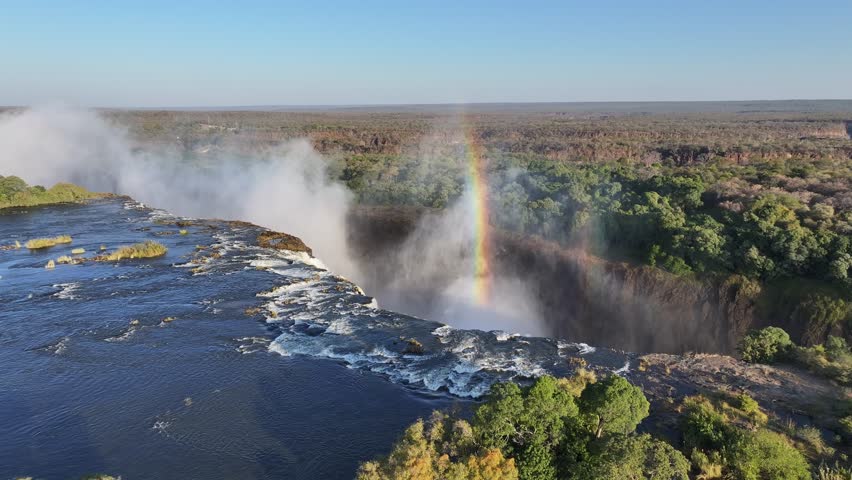 Victoria Falls In Livingstone Northern Rhodesia Zambia. Powerful Waterfall Cascading Over Rocky Cliff Into Mist. Nature Sky Mountain Canyon. Nature Panoramic. Livingstone Northern Rhodesia.