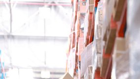 Senior warehouse worker positioning ladder and activating connectivity icons while retrieving box. Logistics, automation, industrial, technology, efficiency, supply chain, warehousing - Powered by Shutterstock - Get 15% off with code: PIKWIZARD15