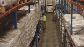 Logistics team scanning stock with scanner and activating floating icons as manager entering aisle. Inventory, supply chain, digital transformation, warehouse, technology, logistics, teamwork - Powered by Shutterstock - Get 15% off with code: PIKWIZARD15