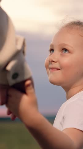 Mother daughter walking together holding hands outdoors, child girl smile. Little daughter, mother holding hands walking in summer park. Happy family. Parent child happy childhood. Happy family travel