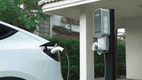 Electric vehicle technology utilized to residential area or home charging station for EV car battery recharge. Eco-friendly transport by clean and sustainable energy for future environment. Fastidious - Powered by Shutterstock - Get 15% off with code: PIKWIZARD15