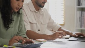In their living room, a Hispanic couple contemplates loan conditions, bills, and economic challenges, supporting each other through financial decisions.

 - Powered by Shutterstock - Get 15% off with code: PIKWIZARD15