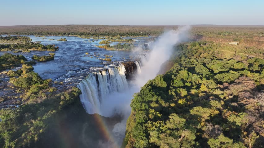 Victoria Falls In Livingstone Northern Rhodesia Zambia. Powerful Waterfall Cascading Over Rocky Cliff Into Mist. Leisure Falls Water Falls Beautiful Day.