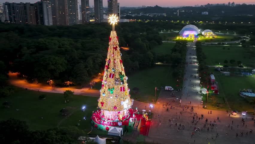 Sunset Christmas Tree In Candido Portinari Park Sao Paulo Brazil. Aerial View Of Christimas Tree And Ornaments To Happy Holidays. Building Industrial Skyline Birds View Stunning.