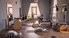 Woman training pilates on the reformer bed. Reformer pilates studio machine for fitness workouts in gym. Fit, healthy and strong authentical body. Fitness concept - Powered by Shutterstock - Get 15% off with code: PIKWIZARD15