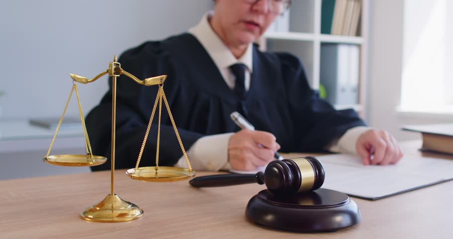 Close up shot of a judge uses hammer gavel during courtroom hearing, delivering judgment on law in a legal setting with focus on verdict and justice in a criminal case with authority and decision.