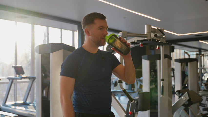Man drinking protein shake in gym