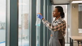 African American worker cleaning office window glass - Powered by Shutterstock - Get 15% off with code: PIKWIZARD15