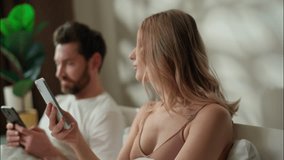 Addicted Caucasian family pair typing mobile phones in bedroom addict couple gadget problem separate husband scrolling social media network online bed woman using Internet web apps man ignoring wife - Powered by Shutterstock - Get 15% off with code: PIKWIZARD15