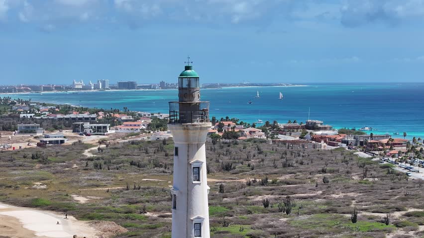 California Lighthouse In Noord Oranjestad Aruba. Aerial View Of A Bustling Ligthhouse In A Coast City. Coast Horizon Seaside Summertime. Coast Outdoor Beach Panoramic. Noord Oranjestad.