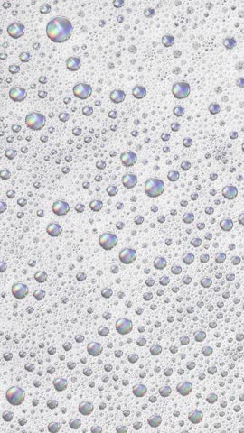 Foam background. Liquid soap bubbles, Froth bubbles backdrop. Soap foam popping bubble rotating, white backdrop. Soap sud macro structure close-up. Clean, cleaning, washing, laundry