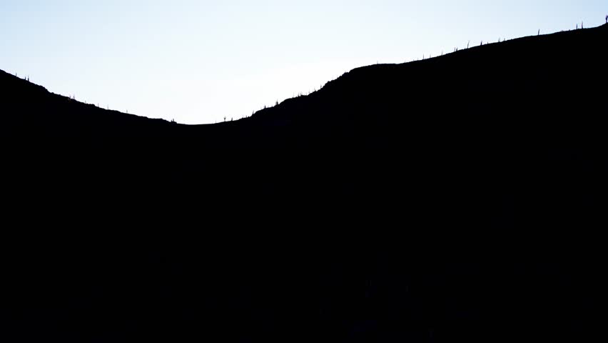 Sunset Reveal Behind a Hill in the Bolivian Highlands – Aerial View