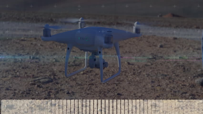 Drone operator powering controller and issuing commands while telemetry overlays animating. Drone, telemetry, data, technology, outdoors, control, sensing