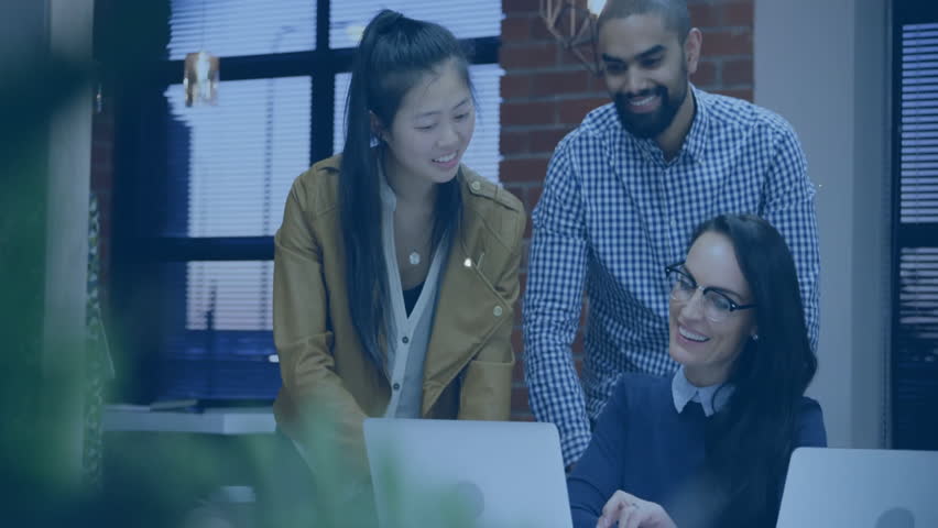 Project team scrolling laptop screen in tech office, building animated network overlay with icons. Collaboration, teamwork, digital, networking, innovation, communication, modernity - Powered by Shutterstock - Get 15% off with code: PIKWIZARD15