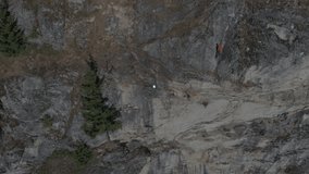 Drone filming cliff while tech overlay expanding linking file icons from user icon above climbers. Technology, connectivity, networking, digital, innovation, collaboration, data - Powered by Shutterstock - Get 15% off with code: PIKWIZARD15