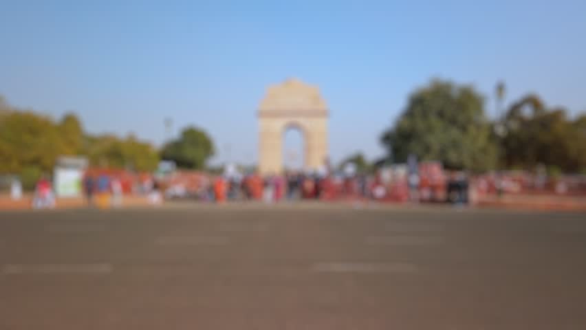 Bokeh view of tourists visit India Gate in New Delhi, India. Blurred background footage.