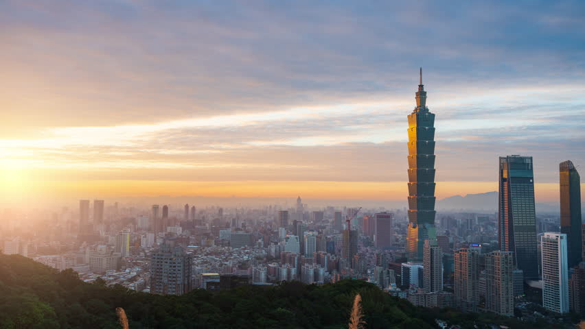 Day to night, Time lapse aerial view of Taipei, the capital of Taiwan, and a beautiful sunset sky.