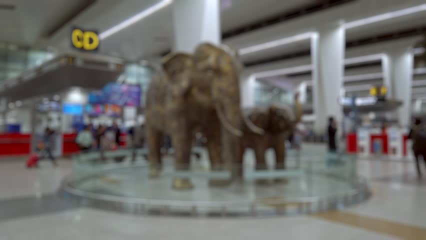 Bokeh view of departure zone of Indira Gandhi International Airport in New Delhi, India. Blurred background footage.