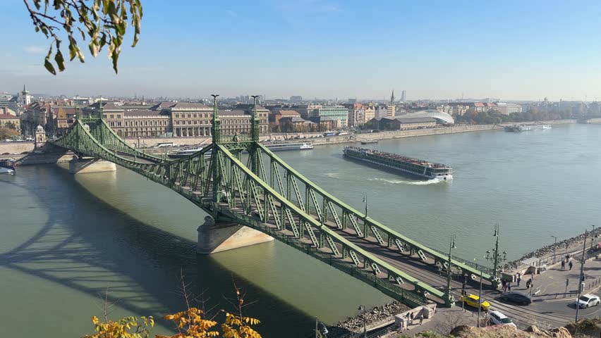 Liberty bridge of the 19th century over river Danube in Budapest,  Hungary, general view from the Gellert Hill in autumn sunny day 
