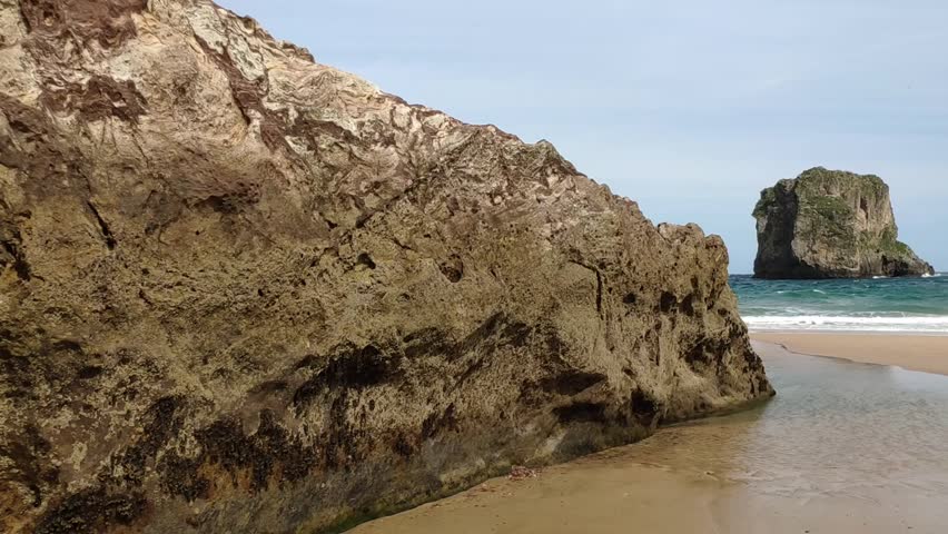 Breathtaking view of Castro Ballota Islet from Ballota beach in Asturias, Spain