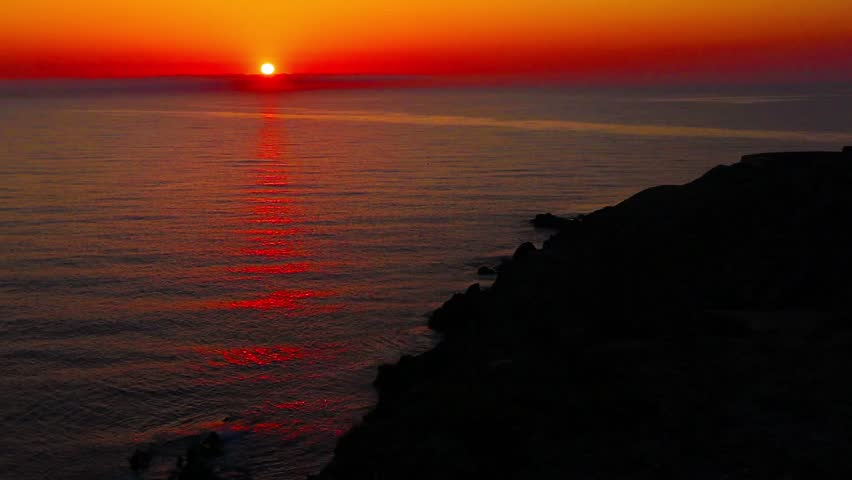20-second video still shot of Cap Béar overlooking the Mediterranean Sea at Port Vendre in the South of France, with waves and cliffs under a beautiful sunrise.