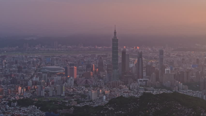 Sunrise Aerial skyline of Downtown Taipei at dusk, vibrant capital city of Taiwan, with 101 Tower standing out amid skyscrapers in Xinyi Commercial District and 