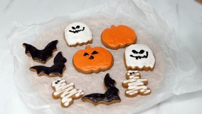 Women's hands coloring Halloween cookies. Halloween concept. Holiday atmosphere. Preparing for the Halloween party. 4k footage. - Powered by Shutterstock - Get 15% off with code: PIKWIZARD15