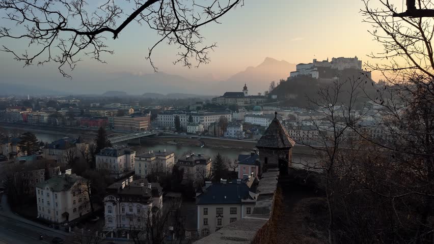 Salzburg, Austria: Dramatic sunset over Salzburg medieval old town with the famous Fortress Hohensalzburg. Shot from the Basteiweg trail on the other side of the Salzback river. 