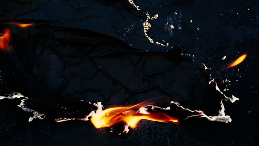 Burning and glowing edge of paper with fire flame and smoke on black background