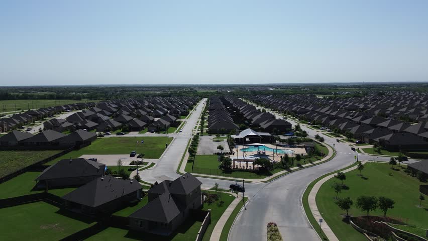 Urban sprawl rapid outward expansion of McKinney and Princeton, fast growing area of Collin County, outside Dallas Fort Worth Metroplex, community living amenities pool, shaded playground, flyover. US