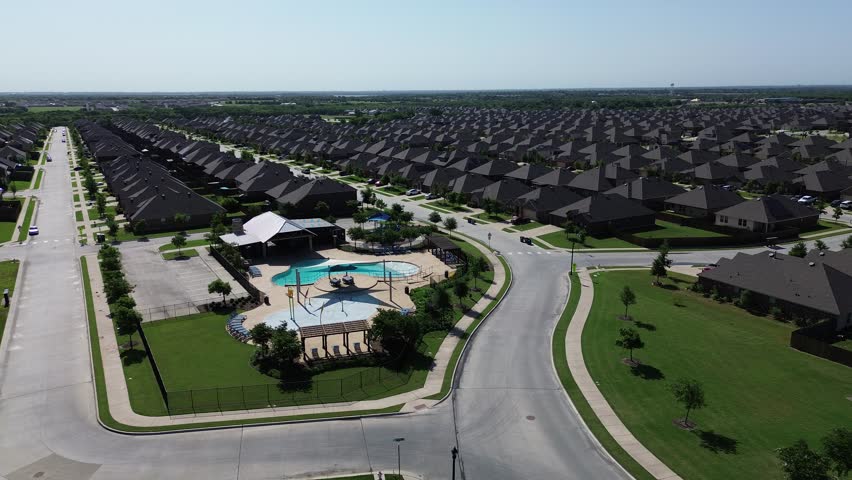 Community recreational facilities with swimming pool, shaded playground, picnic area in new construction homes area, fast growing Dallas Fort Worth suburb, Princeton, Collin County, Texas flyover. USA