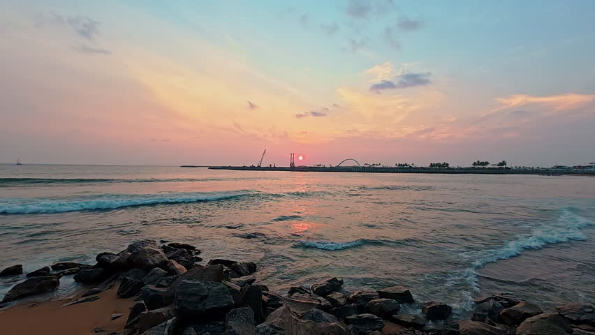Landscape twilight dusk golden sunset over tranquil gentle wave at Galle Face beach, Colombo, Sri lanka. 4K video.