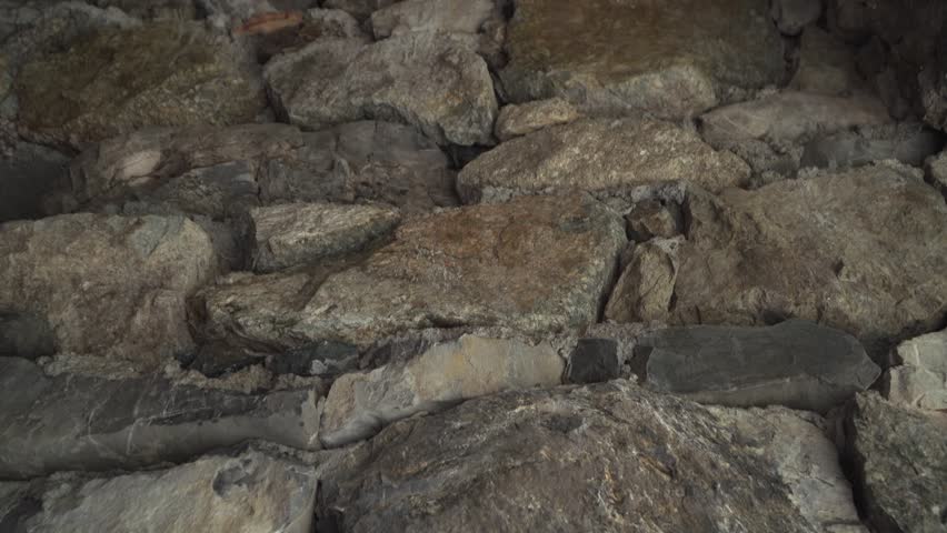 Tilt down on white stone icons of St. Nicholas and St. Panteleimon embedded in the wall. Bulgarian Orthodox chapel of the same name, made of stone, near Rai hut. Masonry. Bulgaria