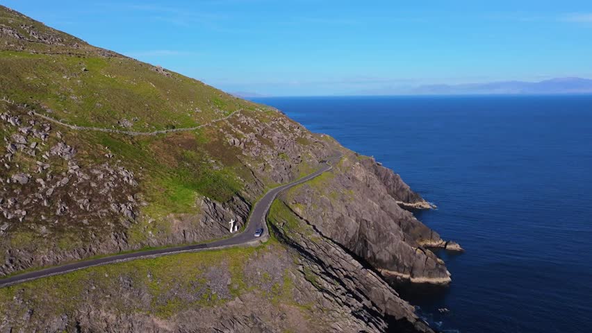 Iconic Slea Head coastline glowing in bright sunlight and deep blue skies - Dingle Co.Kerry - 4K Cinematic Drone Footage 03