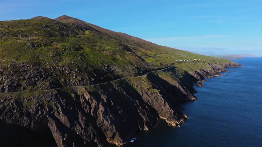 Iconic Slea Head coastline glowing in bright sunlight and deep blue skies - Dingle Co.Kerry - 4K Cinematic Drone Footage 04