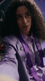 Vertical POV shot of enthusiastic young biracial fashion model looking at camera while recording video vlog and showing her stunning lilac designer outfit sitting in professional studio - Powered by Shutterstock - Get 15% off with code: PIKWIZARD15