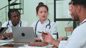 Medical professionals analyzing patient data, discussing diagnosis while reviewing information on digital devices during collaborative healthcare team meeting - Powered by Shutterstock - Get 15% off with code: PIKWIZARD15