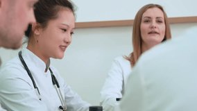 Medical professionals engage in a collaborative discussion, reviewing case files and strategies. Focus on team dynamics and shared decision-making in healthcare settings - Powered by Shutterstock - Get 15% off with code: PIKWIZARD15