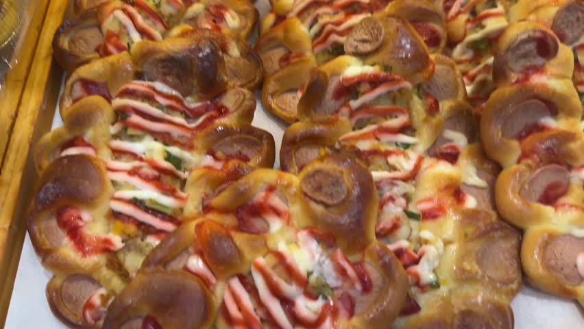 long portion pizzas Composition of hot tasty baked sandwiches with various toppings. Cheese, tuna, mozarella, olives, spices, zucchini, tomato. Delicious homemade food. Top view.