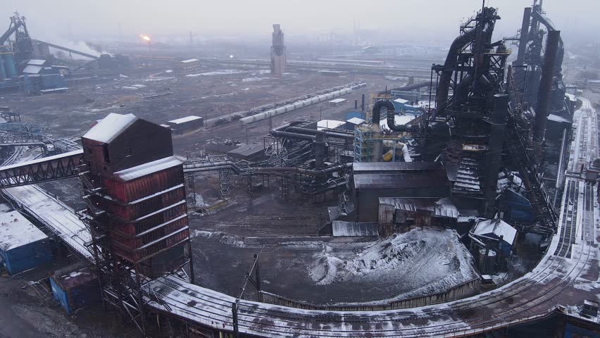 Zug Island steel mill in Detroit, USA with snow-dusted blast furnaces and train tracks