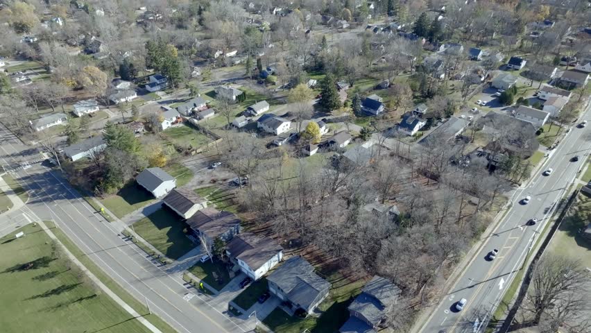 Neighborhood homes in East Lansing, Michigan with drone video moving in.