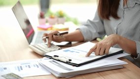 Accountant working at desk using calculator to calculate financial report in finance accounting business office concept - Powered by Shutterstock - Get 15% off with code: PIKWIZARD15