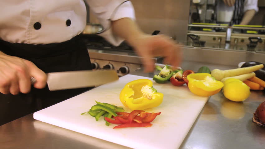 Chef slicing peppers