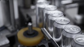 Automated beer can sealing process in brewery factory, precision and efficiency in action - Powered by Shutterstock - Get 15% off with code: PIKWIZARD15