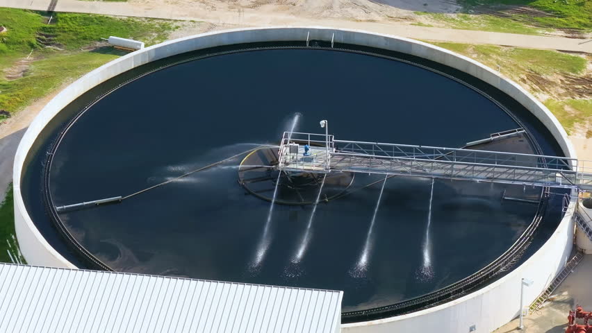 Large-scale industrial water treatment plant purifying and recycling water through filtration and chemical processes to meet health and safety standards.