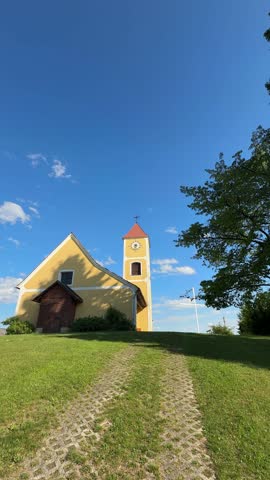romantic church on hill with white cross in Austria