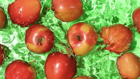 Whole red apples falling into water, splash water, slow motion. - Powered by Shutterstock - Get 15% off with code: PIKWIZARD15