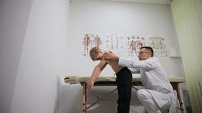 A healthcare professional evaluates the child's posture and spine - Powered by Shutterstock - Get 15% off with code: PIKWIZARD15