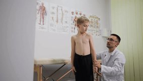 A pediatric healthcare doctor is conducting a thorough checkup on a young boy in a medical clinic setting - Powered by Shutterstock - Get 15% off with code: PIKWIZARD15