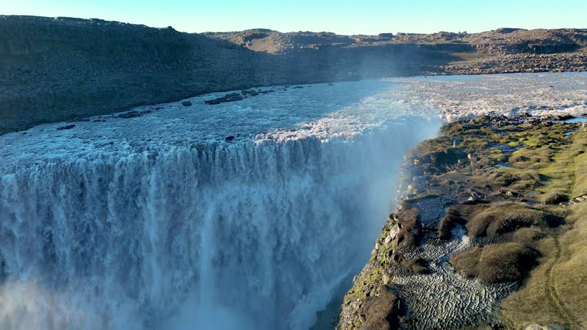 Experience the breathtaking view of Dettifoss waterfall in Iceland, where powerful waters plunge dramatically amidst stunning natural beauty. This awe-inspiring site reveals raw wilderness.